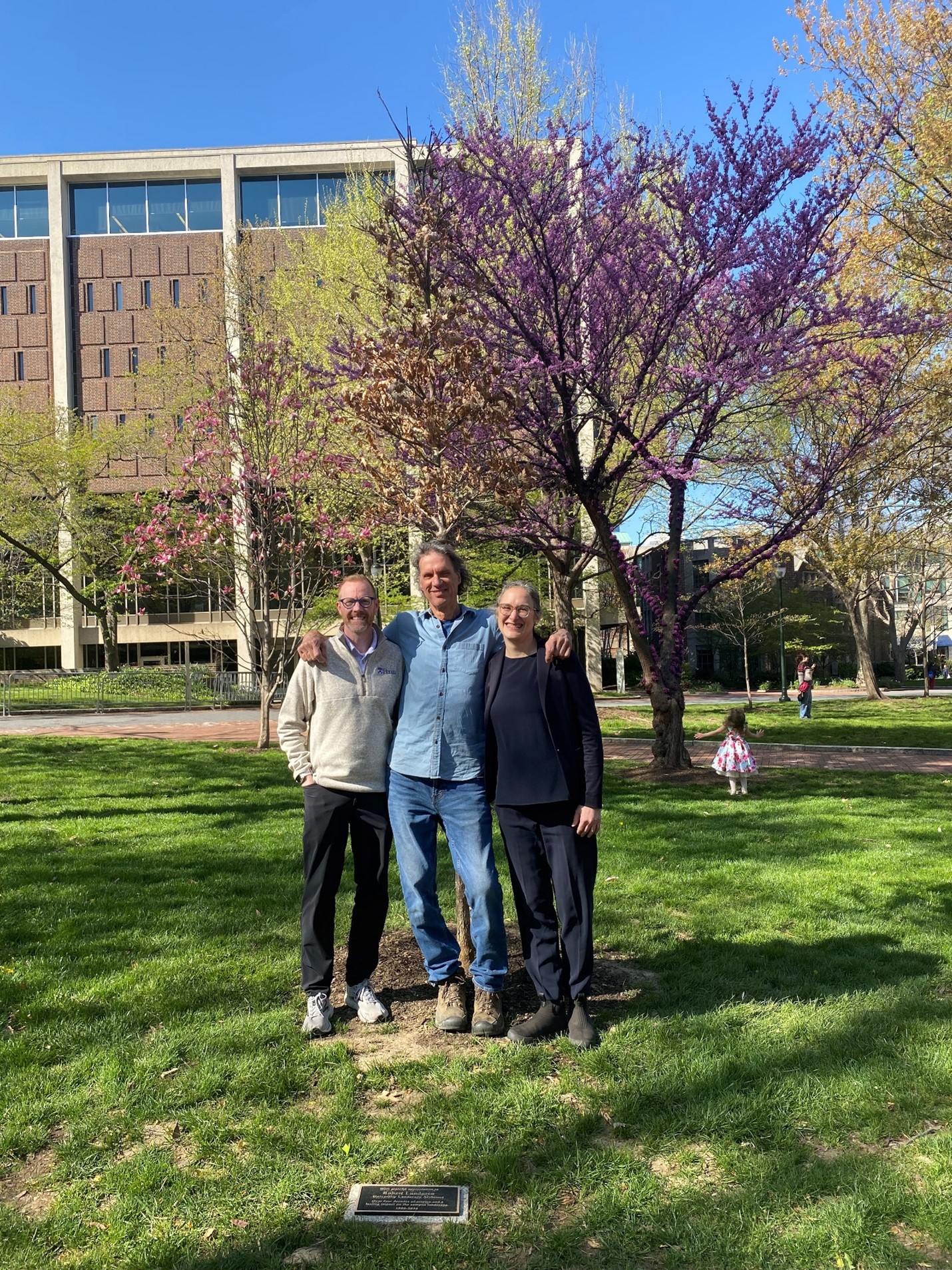 University Landscape Architect Brent Lewis, former University Landscape Architect Bob Lundgren, and Landscape Planner Chloe Cerwinka at College Green celebrating Lundgren’s decades of service