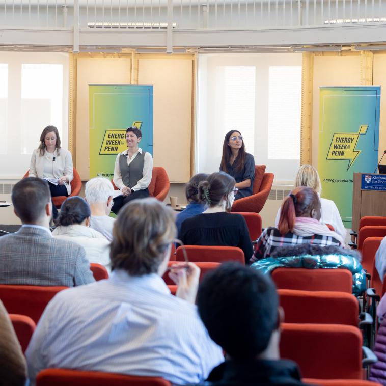 seminar in a bright room with five people as speakers