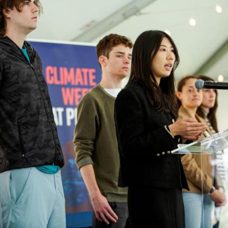Students speaking at a podium