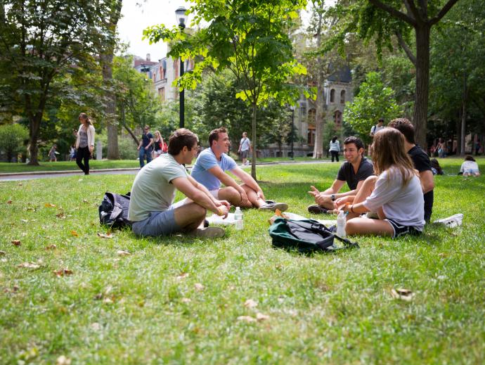Student sitting in circle on grass