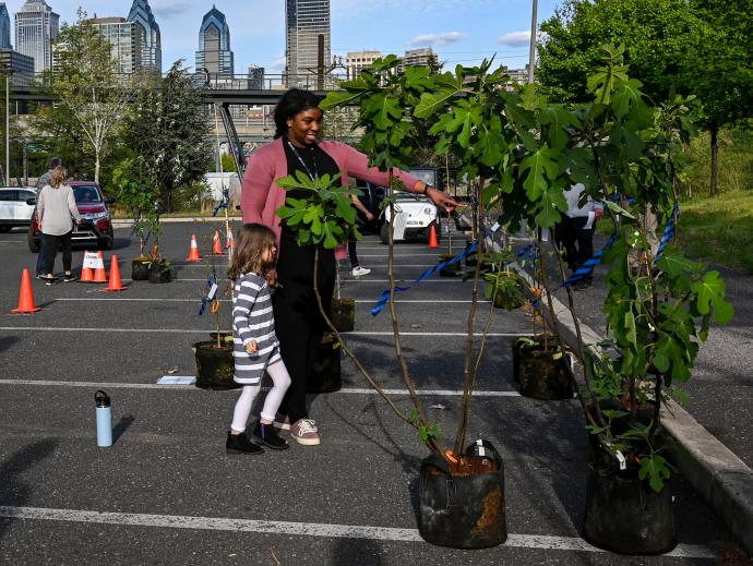 A woman and child select a tree