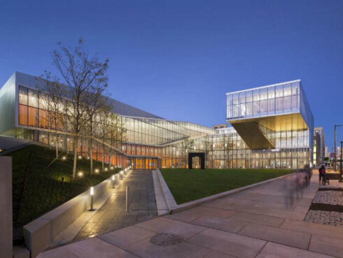 Three quarters view of sidewalk leading up to main entrance of the Singh Center