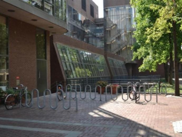 Rows of empty bike racks in front of Vance Hall