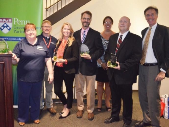 Group that developed the program standing together and holding their award