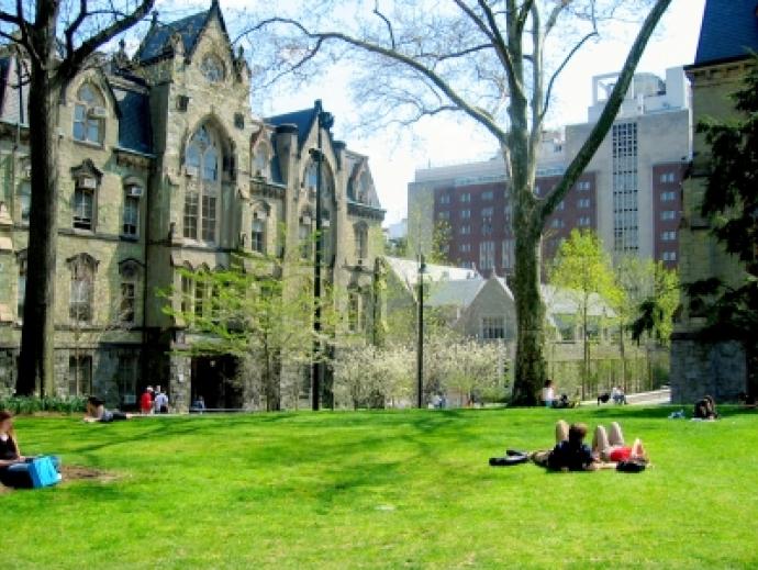 students lounging on college green