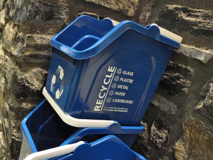stacked blue recycling bins with handles