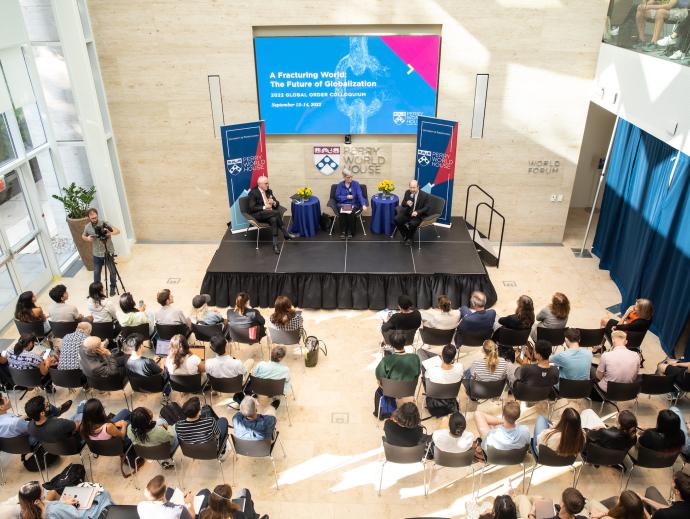 overhead image of event at Perry World House with three people on stage