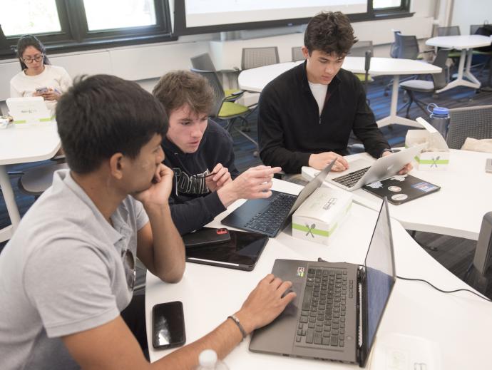 students at table with project
