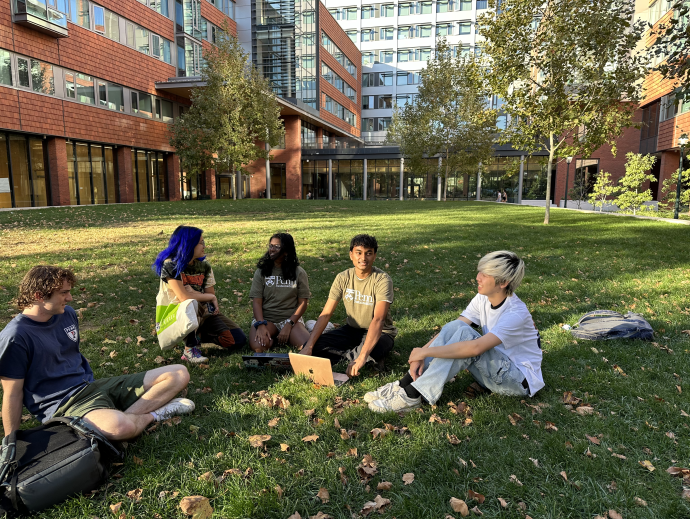 Smiling group of students sitting in the grass