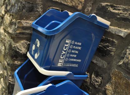 stacked blue recycling bins with handles